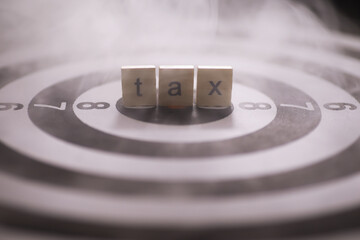 Tax Concept with Wooden Cubes on Bullseye Target Background Symbolizing Financial Focus