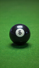 Ultra realistic close-up of a glossy black 8-ball reflecting overhead lights, set on a green felt pool table, shallow depth of field, cinematic lighting
