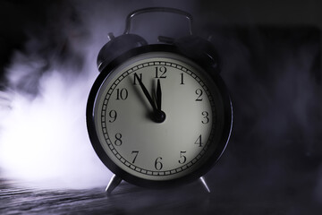 Vintage Alarm Clock at Midnight Surrounded by Mysterious Fog and Emerging Light