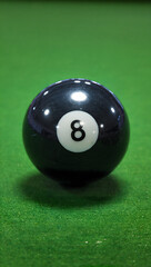 Ultra realistic close-up of a glossy black 8-ball reflecting overhead lights, set on a green felt pool table, shallow depth of field, cinematic lighting