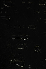 Dark Abstract Background with Glossy Water Droplets on Black Surface