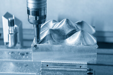The CNC milling machine rough cutting the mold parts by indexable tools in the blue tone.