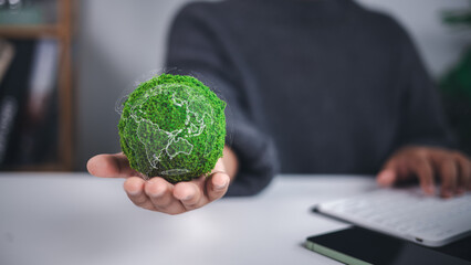 Environmental protection is symbolized by a moss covered green globe with a translucent world map held in hand, representing sustainability, ecological care, and global conservation efforts.