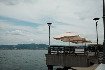 Cozy outdoor cafe table and chairs by the Danube River in Serbia, with a beautiful view of the...