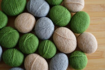 Natural smooth stones in green gray and beige hues on wood surface