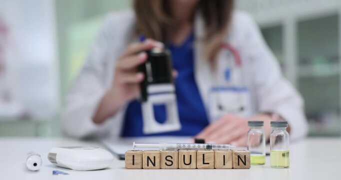 Wooden blocks form word Insulin reflecting hormone importance. Lab glassware stands on desk showing clinical context by doctor stamping prescription
