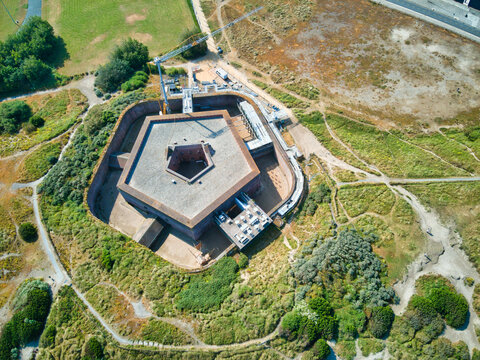 Aerial view of Fort Napoleon's sturdy brick walls and geometric design stand in contrast to the green dunes and sandy pathways, Ostend, West Flanders, Belgium.