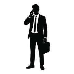 Obraz premium Silhouette of a businessman in a suit talking on a cell phone and holding a briefcase