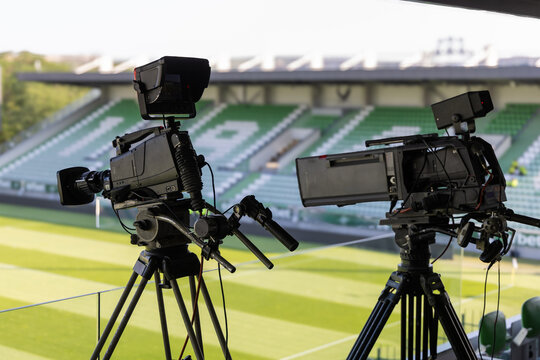 Professional television cameras for live broadcasting a sports event in a stadium. Behind the scenes of media production.