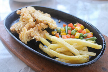 Hot Plate of Fried Chicken Strips with French Fries and Colorful Vegetables