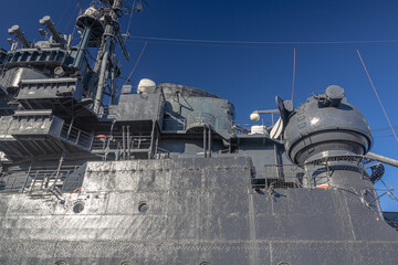 The museum ship is moored at the eternal parking lot in the port of Novorossiysk. A Soviet cruiser in the port. A warship with guns. 