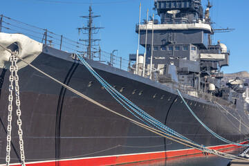 The museum ship is moored at the eternal parking lot in the port of Novorossiysk. A Soviet cruiser in the port. A warship with guns. 