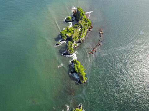 Aerial view of a rugged island with vibrant green vegetation surrounded by turquoise waters, creating a stunning contrast, Limbe, Southwest Region, Cameroon.