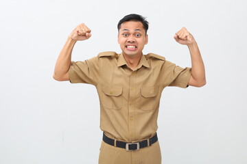 Successful Indonesian civil servant man standing while lifting and clenching her hand