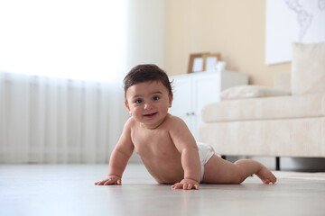Cute little baby crawling on floor at home