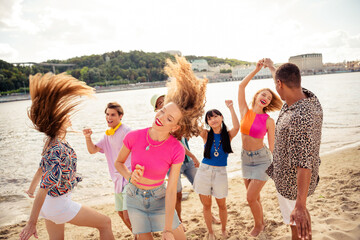 Fellows celebrating together on a sunny beach during summer vacation enjoying fun bonding moments