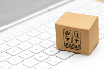 Fragile Package on Computer Keyboard Representing Online Shopping and Delivery Handling