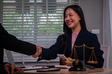 In the company's law office, a businessman secretly hands over dollar bills with contracts,...