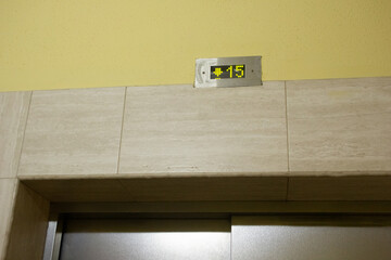 photos of elevator doors in an apartment building with neutral colors