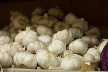 shelves in a vegetable store, brightly colored vegetables and fruits garlic 