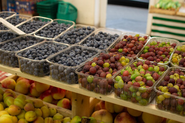 shelves in a vegetable store, brightly colored vegetables and fruits berries