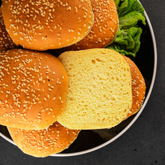 Bun burger puffy soft buns baking fresh delicious gourmet food background on the table rustic food top view copy space