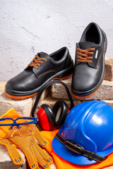 Personal protective safety equipment and old bricks on wooden background