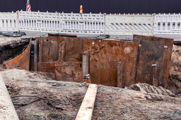 Repair of a pipeline accident. A large hole dug in the middle of a road