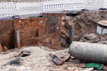 Repair of a pipeline accident. A large hole dug in the middle of a road