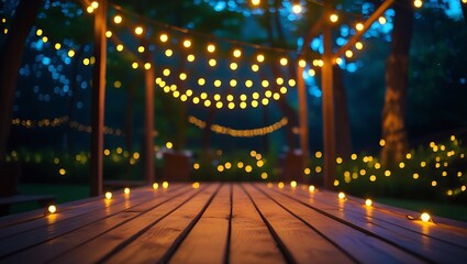 Empty Wood table top with decorative outdoor string lights hanging on tree in the garden at night time	
