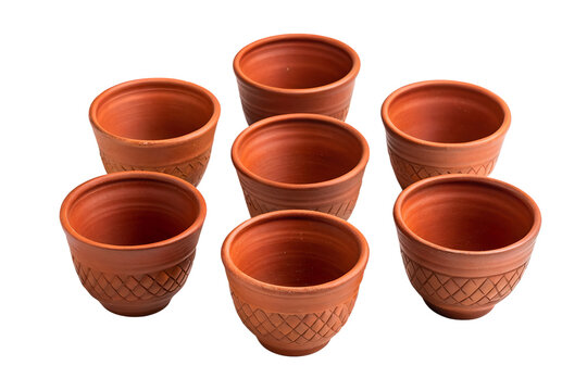 A set of traditional handcrafted terracotta clay tea cups. Indian earthenware pottery kullad mugs isolated on white.