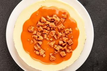 Cheesecake salted caramel sweet dessert fresh delicious gourmet food background on the table rustic food top view copy space