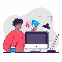 Graphic designer working with color palette at desk