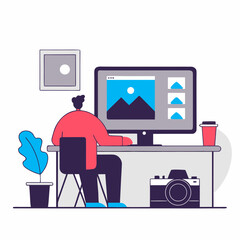 Photographer editing images on desktop computer