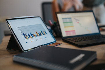 Couple discuss financial options with a bank advisor, highlighted by tablets displaying financial...
