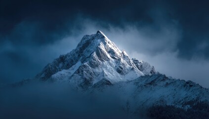 Obraz premium Majestic snow-capped peak bathed in ethereal light