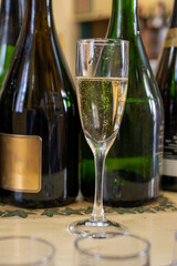 Pouring and tasting of dry sparkling wine brut, grand reserve, champagne in Ay-Champagne wine making village in Vallee de la Marne, , Champagne region, France