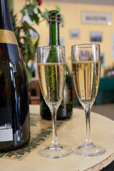 Pouring and tasting of dry sparkling wine brut, grand reserve, champagne in Ay-Champagne wine making village in Vallee de la Marne, , Champagne region, France