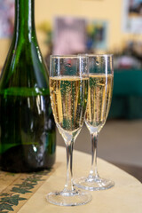 Pouring and tasting of dry sparkling wine brut, grand reserve, champagne in Ay-Champagne wine making village in Vallee de la Marne, , Champagne region, France