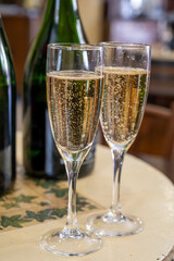 Pouring and tasting of dry sparkling wine brut, grand reserve, champagne in Ay-Champagne wine making village in Vallee de la Marne, , Champagne region, France