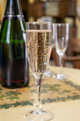 Pouring and tasting of dry sparkling wine brut, grand reserve, champagne in Ay-Champagne wine making village in Vallee de la Marne, , Champagne region, France