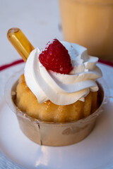 French cuisine, fresh baked baba au rum cake with chantilly cream, sweet dessert with rum close up