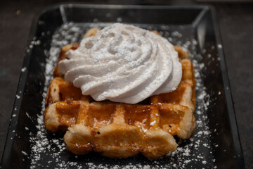 Baked belgian sugar waffles with various toppings, delicious sweet street food in Bruges, Flanders,...