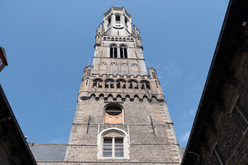 Obraz premium Medieval houses facades and rooftops and city tower with bells in the centre of Bruges, Flanders