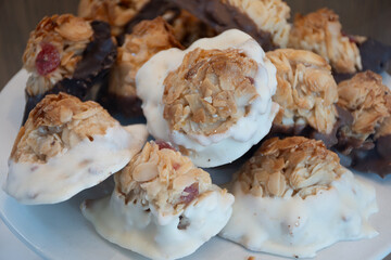 Fresh baked buttered fruit and sweet buns, cakes, pastries in artisan bakery early morning in...