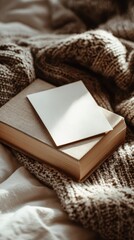 Cozy Reading Environment with Book and Blank Card on Soft Knit Blanket in Warm Natural Light