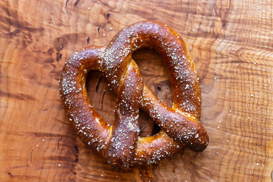 Freshly baked soft pretzels with coarse salt, served with a rustic grainy mustard dip, perfect as a traditional German snack or Oktoberfest appetizer.