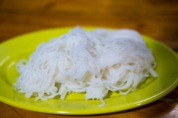 Thai vermicelli (Khanom Chin or slightly fermented noodles) served on a plate. The most popular menu is Kanom Jeen, Fish Curry with Vegetables or Spicy Khanom Jeen Salad.