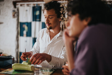 Two individuals are gathered at a rustic-style bar, actively preparing fresh vegetables together, promoting camaraderie and culinary creativity, set in a warm and inviting atmosphere.