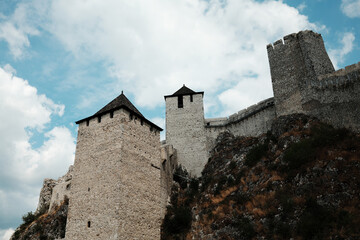 A majestic view of Golubac Fortress with its medieval towers rising against the blue summer sky....